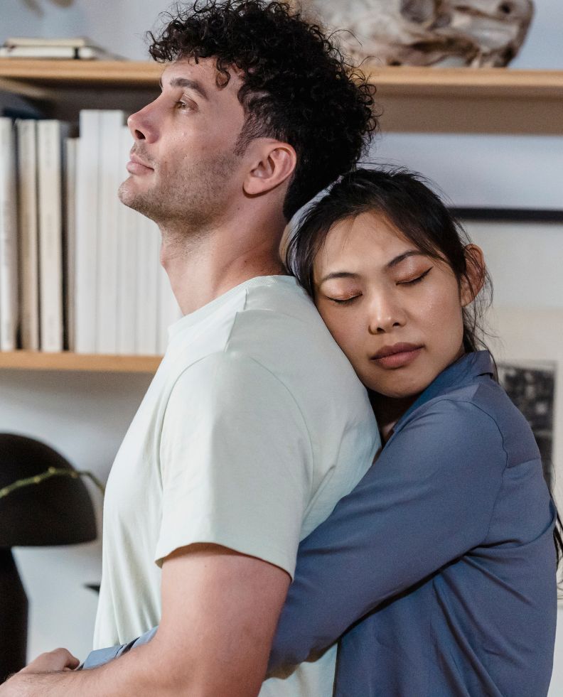 Woman hugging her spouse from behind with her eyes closed representing how healed you can feel after surviving infidelity. Affair recovery programs for surviving infidelity in the United States, Canada and the UK. Schedule a consultation today!
