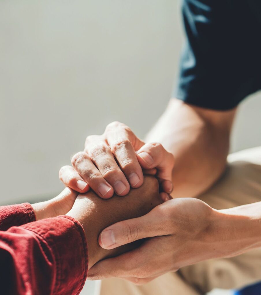 A man and a woman holding hands tightly. You can learn how to apologize for cheating with the help of Relationship Experts in the United States. Book a free consultation with us today!
