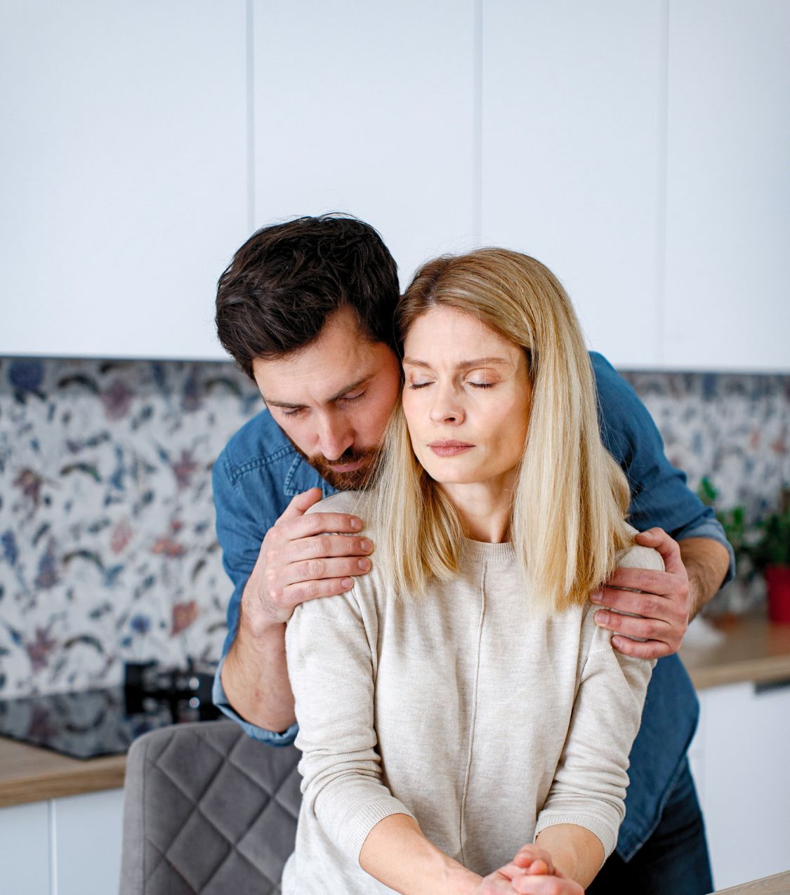 A man is hugging a woman, both looking hurt but trying to recover, as if recovering from an affair. If you are in the same situation and looking for help - we can help. Affair recovery program with Relationship Experts based in Florida, US