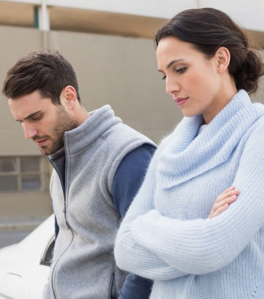 A woman and a man, both with upset faces, look away, symbolizing the fight-or-flight stress in a relationship where the sense of being a team is lost. Trust Relationship Experts in the United States, Canada, and the United Kingdom to assist you in surviving infidelity together. Schedule a free consultation today!