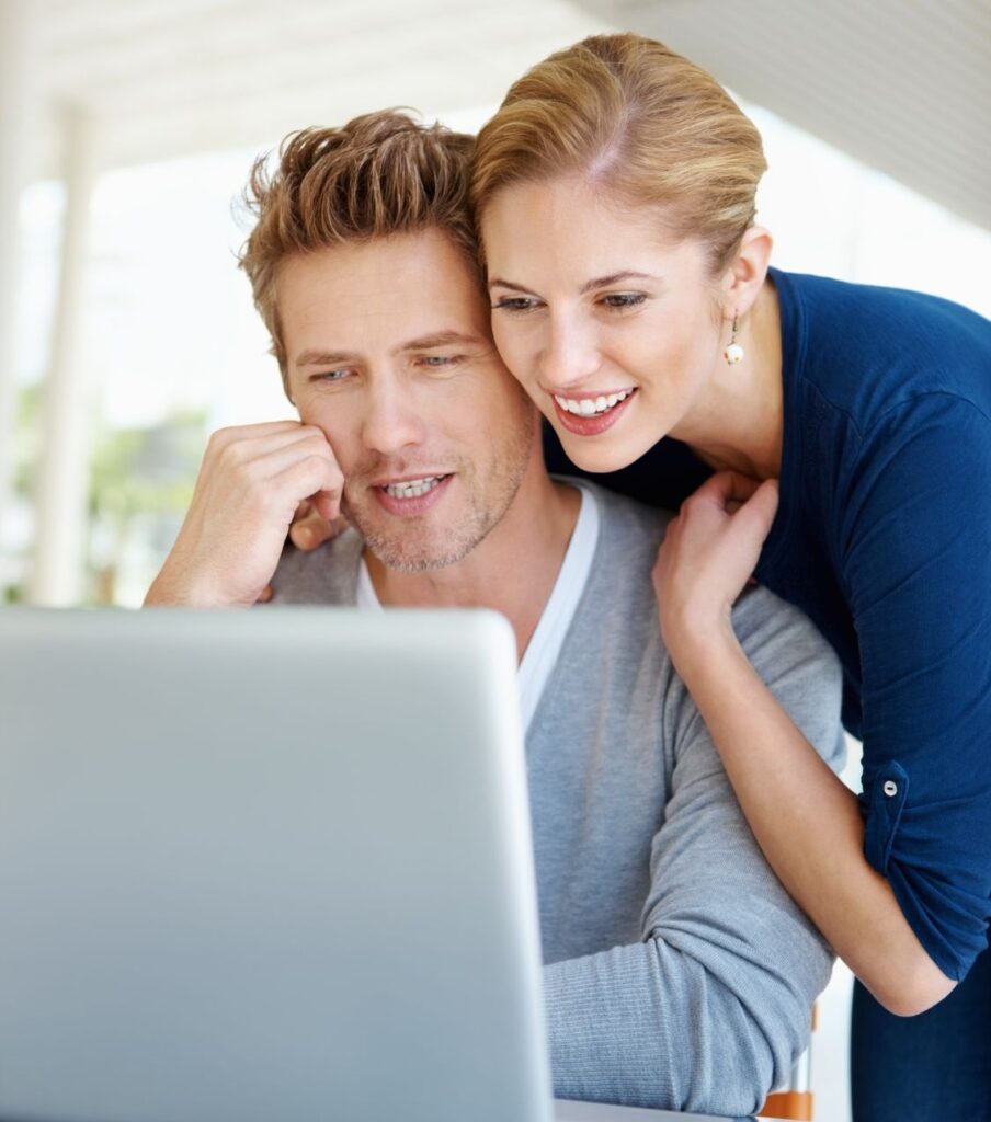 A woman leaning on her partner as they both gaze at a laptop, symbolizing the transformative power of the virtual world in healing real-world relationships. Access skilled and competent infidelity recovery specialists at your fingertips. Schedule a consultation with us in Florida, California, North Carolina, Michigan, Colorado, Ohio, South Carolina, Canada, Australia, and globally.