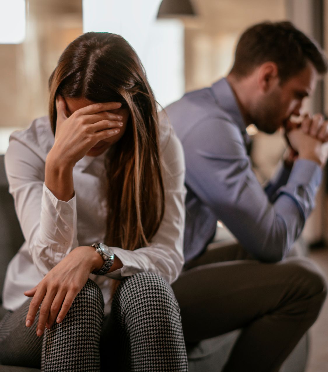 Image of a woman covering her eyes, turning away from her partner, symbolizing the challenges in affair recovery. If you or your partner have cheated and trying to make sense of your relationship, our experts in the United States and globally can help. Contact us in Florida, California, Colorado, New York, North Carolina, and beyond.