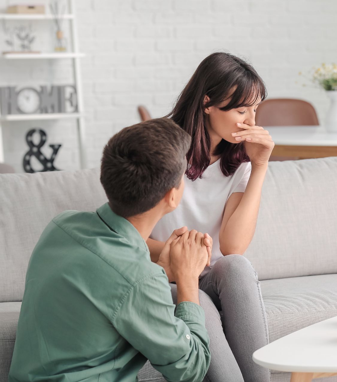 Man kneels beside a sad woman. Infidelity guilt impacts joint recovery & partner responses vary. Book a free consultation with Relationship Experts for support in overcoming infidelity guilt. Serving couples in the United States, Colorado, California, Washington, North Carolina, South Carolina, New York, Illinois, Canada, United Kingdom, Australia & worldwide.