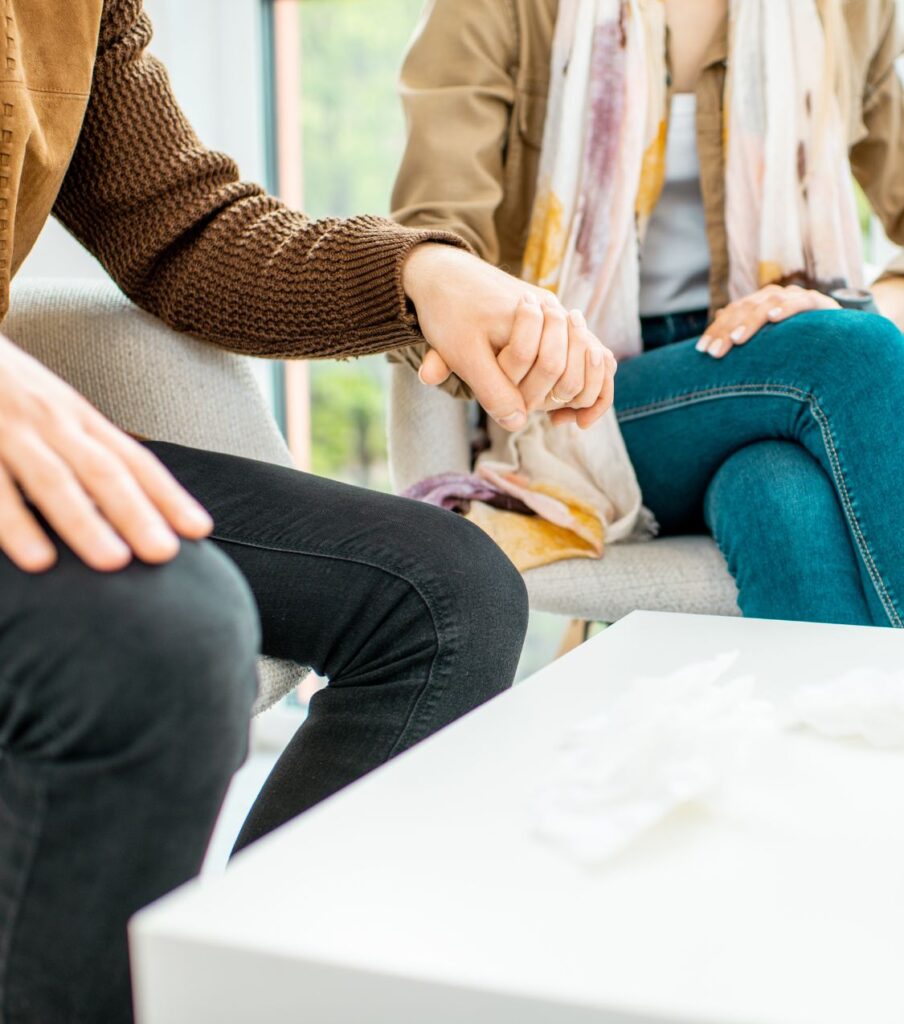A couple holding hands, symbolizing comfort and trust. Discover how to regain trust after infidelity with Relationship Experts. Serving couples in FL, CA, IL, NC, CO, OH, NY, and across the USA and Canada.