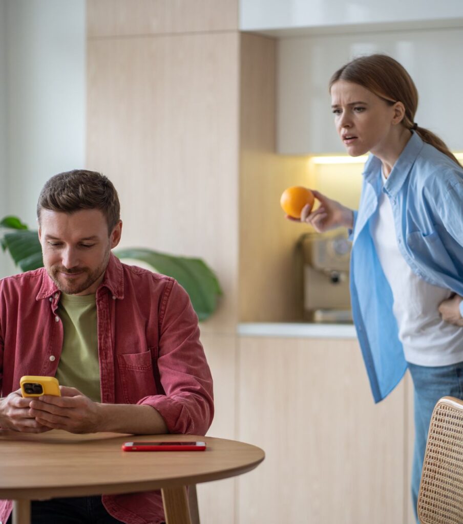A woman glancing at a man's phone, depicting trust issues post-cheating. Discovering how to regain trust after infidelity. Schedule a consultation with Relationship Experts. Helping couples in Virginia, Colorado, New York, California, North Carolina, Ohio, Illinois and Florida in the United States and in Canada 