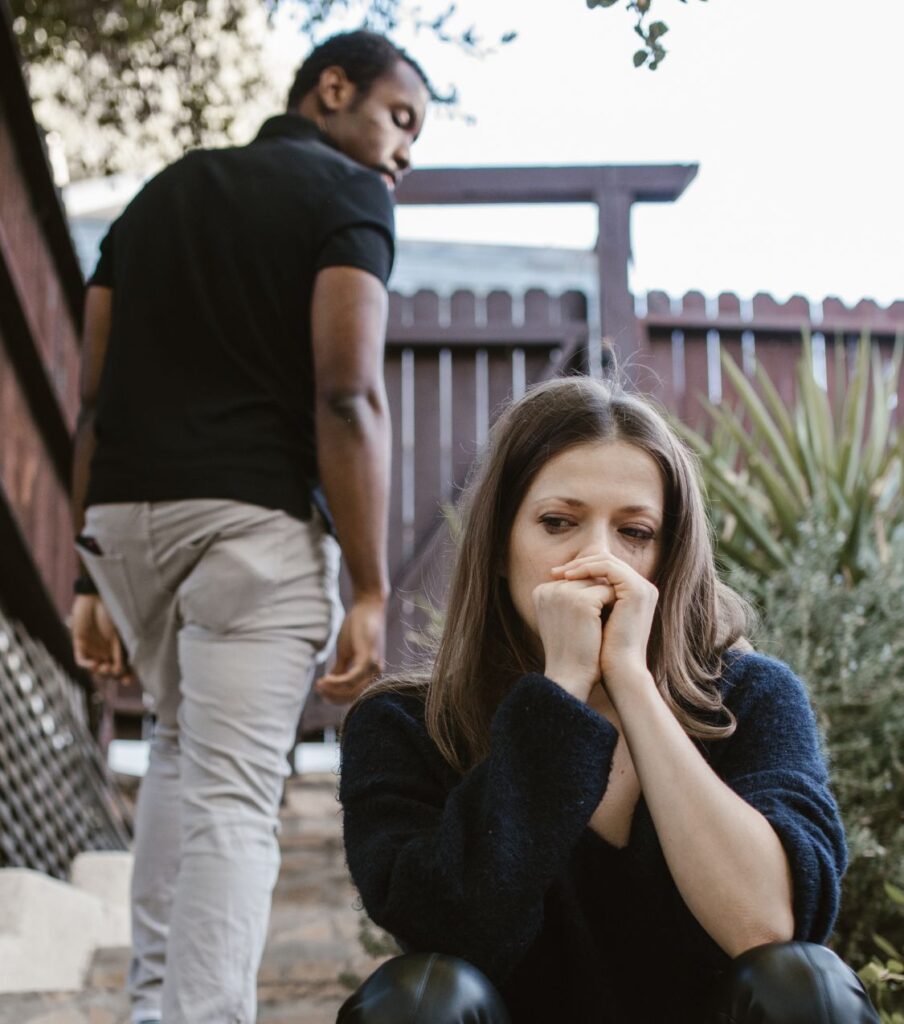 A woman crying while a man walks away, illustrating an unfaithful partner's failure to repair the damage of infidelity. Rebuilding trust without remorse with expert help. Contact us for a free consultation in Colorado, the US, Canada, Australia, the UK, and worldwide.


