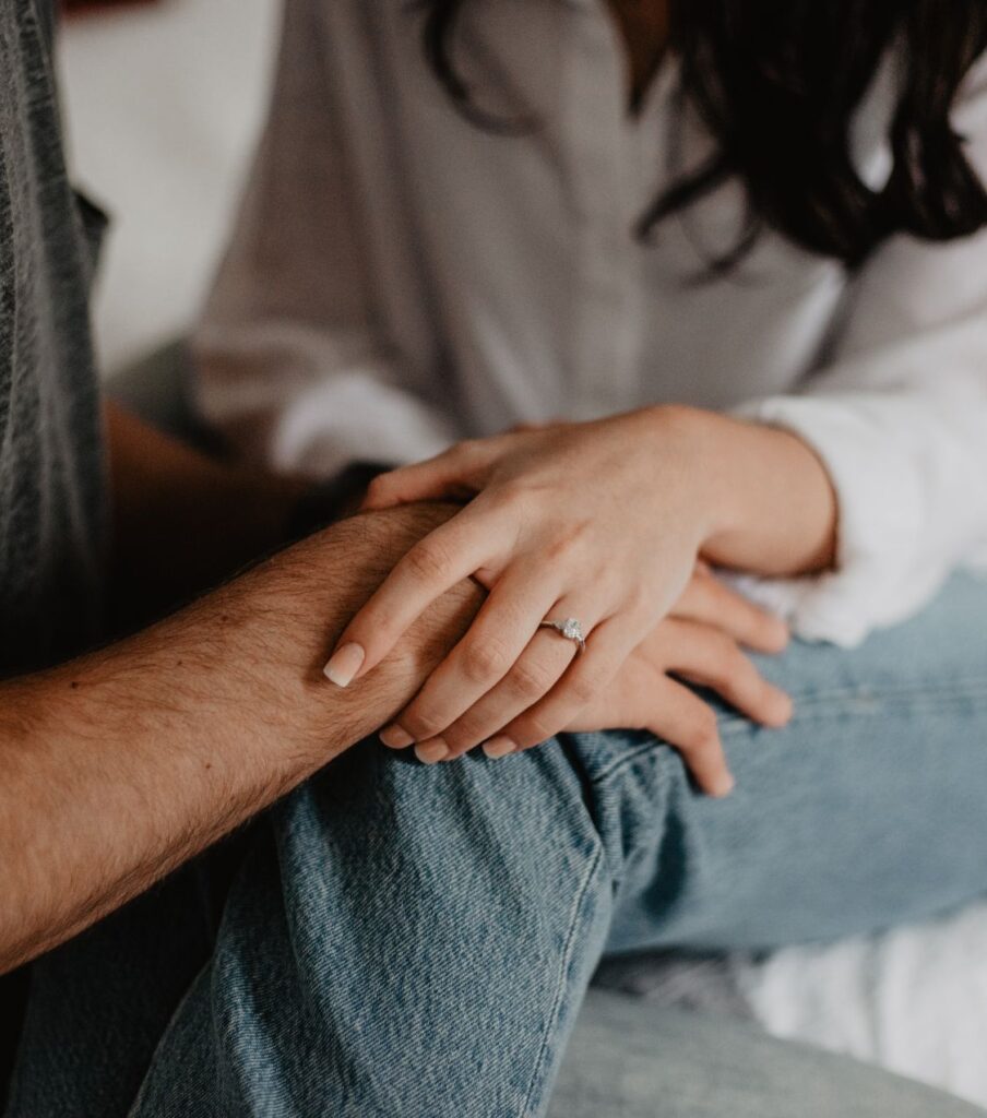 A woman holding a man's hand, illustrating that trust after infidelity can be achieved. Contact Relationship Experts today for healing after cheating. Serving couples in Colorado, the US, the UK, Canada, Australia, and worldwide.