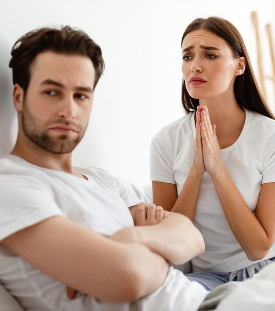 A man looking away from a woman making a begging gesture. Trust after infidelity is crucial for healing after cheating. Contact Relationship Experts for guidance in the US, Colorado, Canada, Australia, the UK, and globally.
