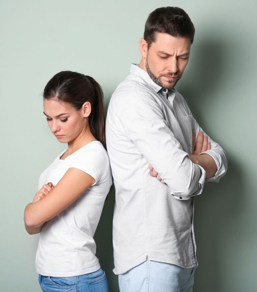 Couple standing back-to-back, symbolizing the endless cycle of infidelity recovery sessions. Relationship Experts offer personalized one-on-one coaching in the USA. Schedule a free consultation today.