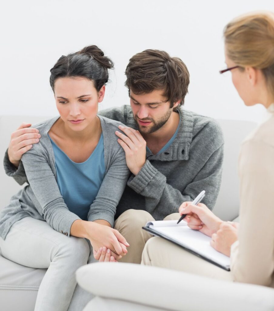 A man hugging a woman during a therapy session as part of an infidelity recovery program to rebuild relationships with a specialist in the USA.