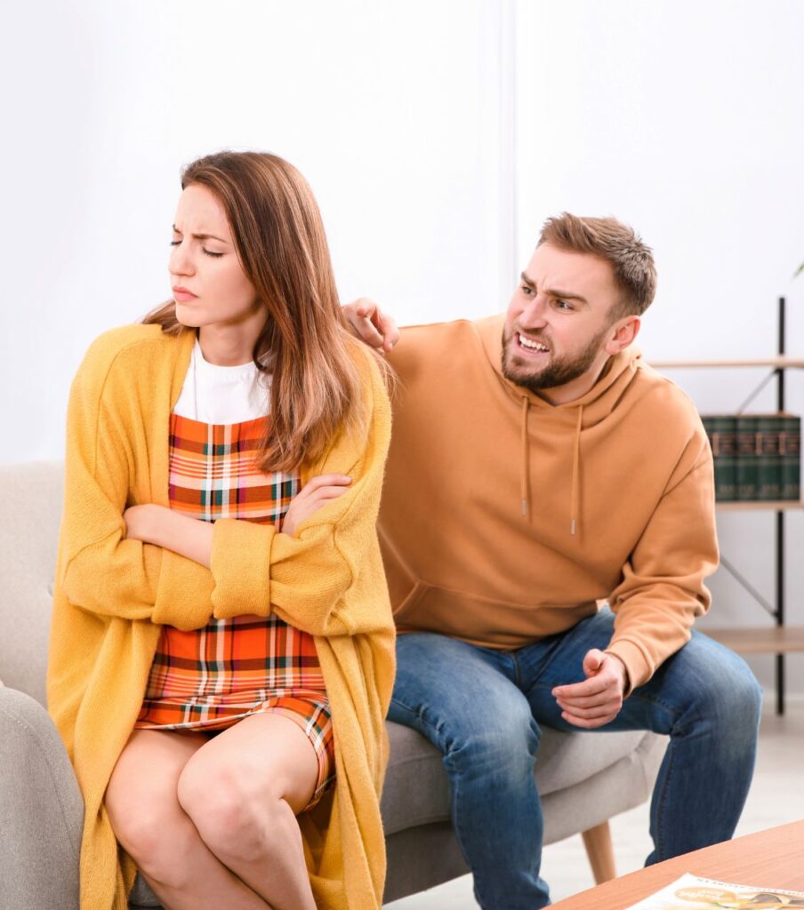 A woman with her eyes closed sits with her back to a man, reflecting the emotional impact of infidelity. Infidelity Recovery Program offers essential support and guidance for couples in the USA and worldwide.





