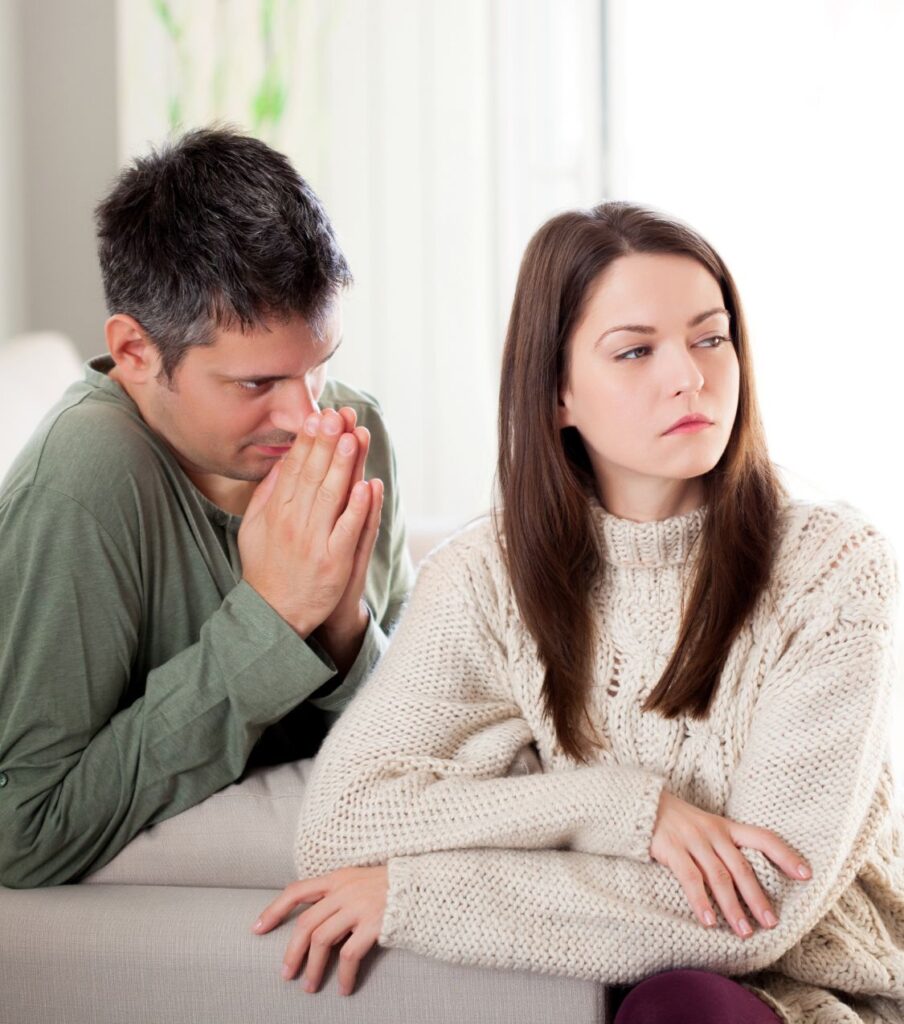 A man asking a woman for forgiveness, representing how to regain trust after cheating and the journey of healing after infidelity with our relationship experts  guidance in the United Sates, in Florida and worldwide.