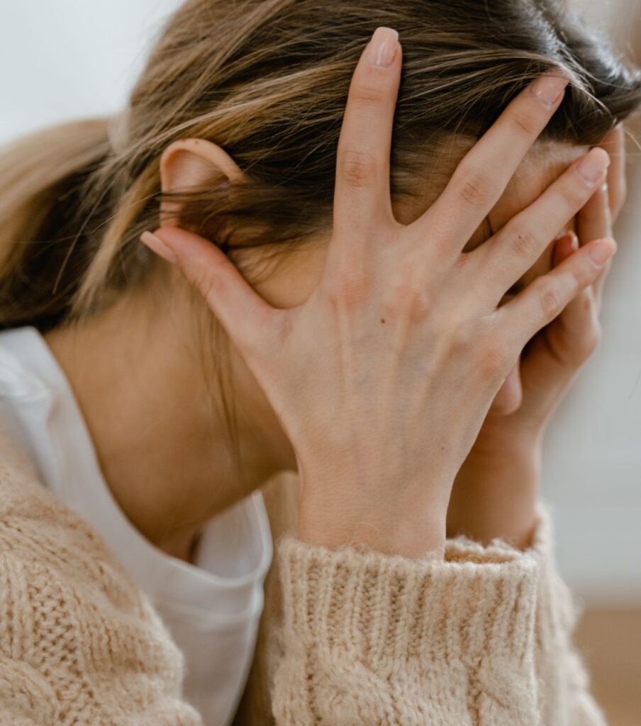 Woman with hands on her face, symbolizing the emotional journey of affair recovery and healing after infidelity with expert support  in the United States, in Canada and globally.   