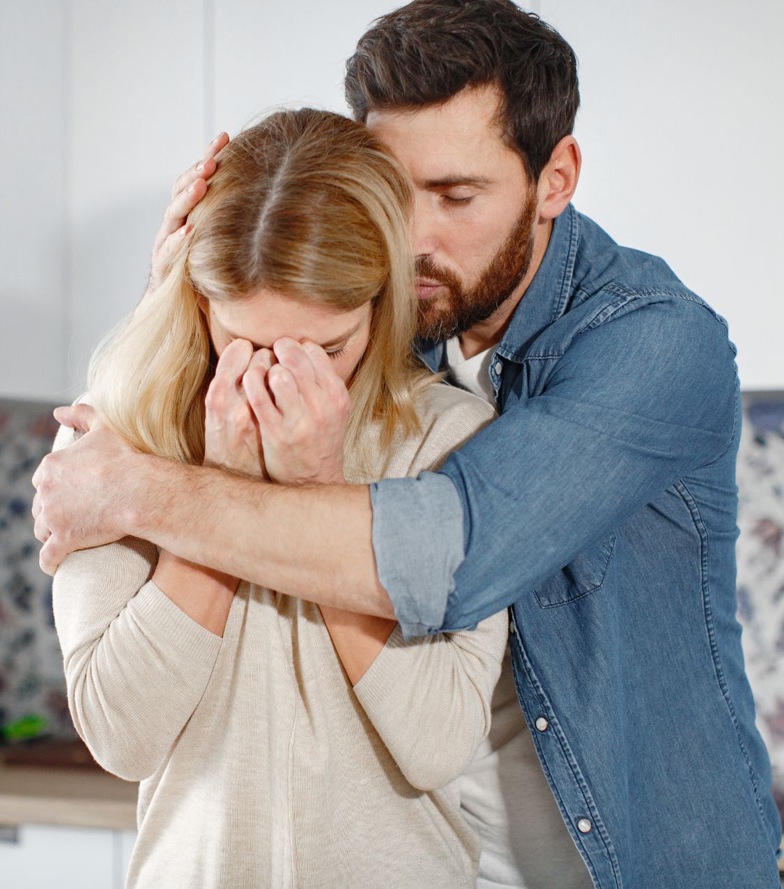 A man hugs a sad woman, symbolizing that forgiveness after infidelity is a part of the infidelity recovery healing process. Relationship experts in Miami Florida, in New York, in Canada and worldwide can help. Schedule a free consultation with us today.