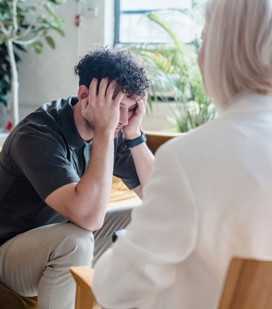 A man sits in front of a woman | Affair recovery program in the USA | How to end an affair in Canada | Missing your partner in the United States | the UK A man sits leaning on his hands across from a woman, appearing conflicted—like someone in therapy who doesn’t know how to end an affair or stop missing their affair partner. Schedule a free consultation to begin healing after an affair. Supporting couples in the USA, Canada, the UK, and worldwide.