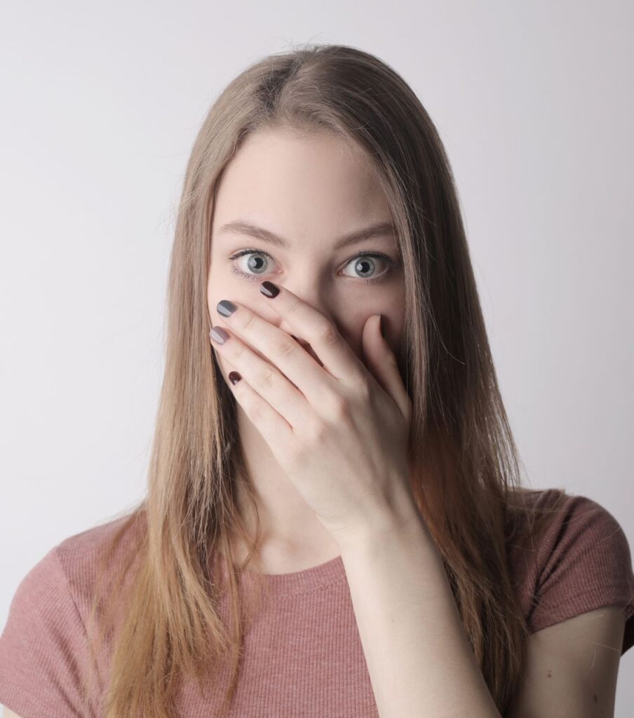 Woman with her hand on her mouth | Affair recovery in the USA | Is my partner a sex addict in Canada | Understand your partner's behavior in the UK Woman with her hand on her mouth, looking shocked after infidelity. Asking: is my partner a sex addict or is it something else? Learn about sex addiction and infidelity with Relationship Experts. Serving clients in the USA, Canada, the UK, and worldwide