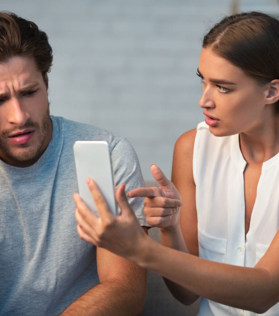 A woman points at a phone beside a man, demanding to know everything he is doing. Therapists can help couples learn how to cope with infidelity. Discover the do's and don'ts after an affair in the USA, the UK, Canada, and worldwide. Schedule a call with our therapists today.