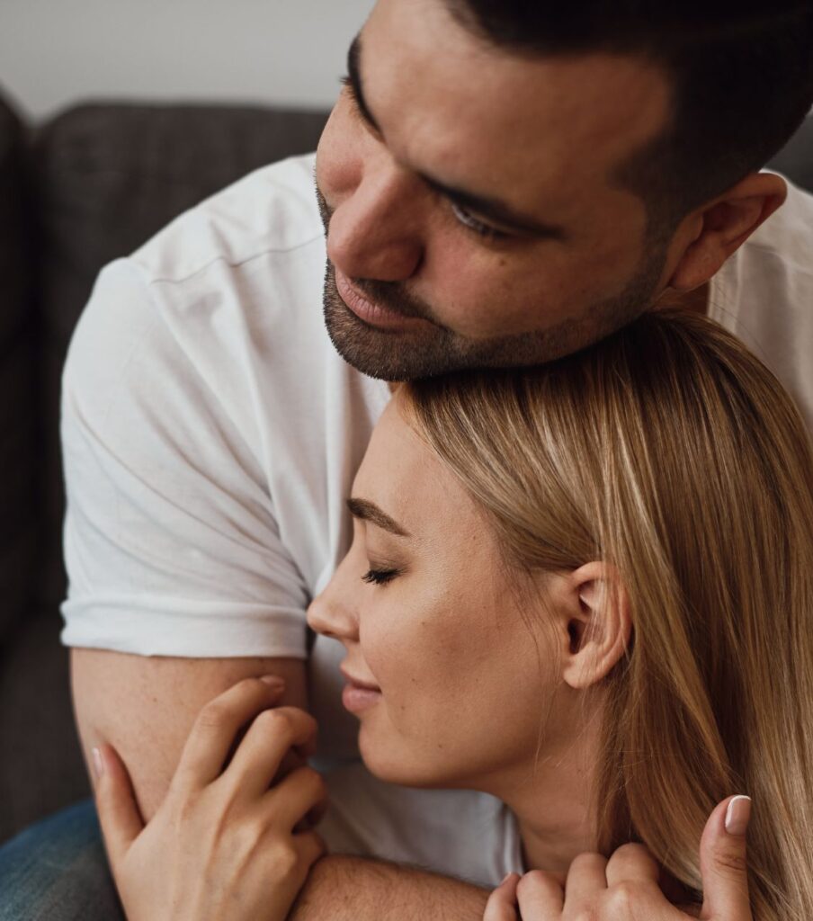 A man hugs a woman after infidelity. The three stages of affair recovery: rebalance, reconnect, restart can help couples heal. Learn about the It's Okay to Stay program in the USA, Canada, the UK, and worldwide.
