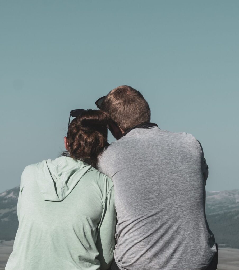 A couple looking toward the mountains after the affair, symbolizing long term connection and how couples heal together after betrayal. Relationship Experts in the USA and worldwide. Take the next step forward together.