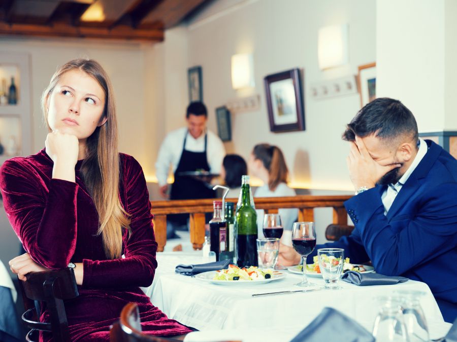 A couple sitting apart at a restaurant table, visibly disconnected and struggling. Capturing what stops couples from healing after infidelity without the right support. Couples in Australia, Dubai, and Doha are discovering that retreats, getaways, and quick fixes aren't enough. A structured approach to marriage recovery is the difference between staying stuck and truly moving forward. Take the first step and reach out to Relationship Experts Online today.